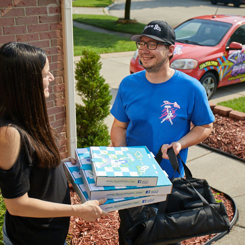 Multiple Revenue Streams - delivery person bringing pizza to smiling customer